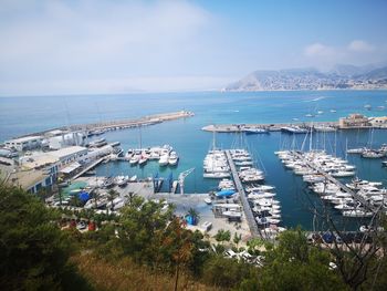 Panoramic view of harbor and sea against sky