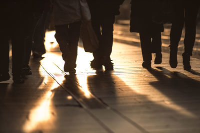 Low section of people walking on floor