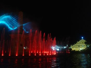 Illuminated fountain at night