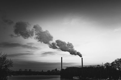 Smoke emitting from chimney against sky