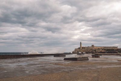 View of beach against cloudy sky