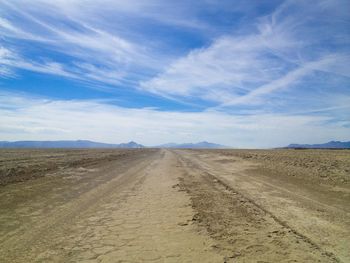 Scenic view of barren landscape against sky