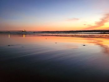 Scenic view of beach against sky during sunset