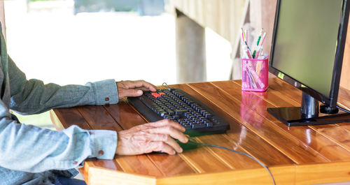 High angle view of person using laptop on table