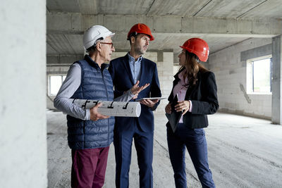 Architects discussing at construction site