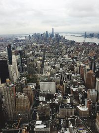 Aerial view of buildings in city against sky