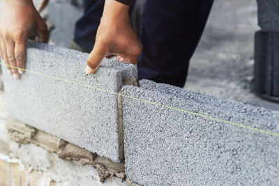 Midsection of man working on concrete