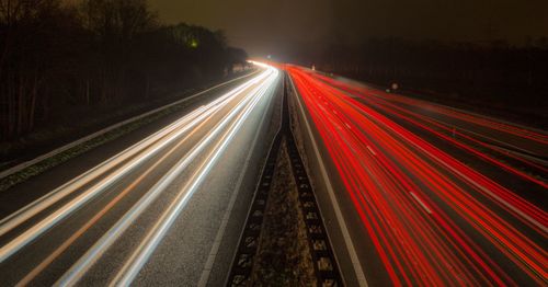 High angle view of light trails on highway at night