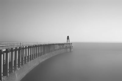 Man looking at sea against clear sky