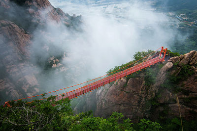 High angle view of footbridge in foggy weather