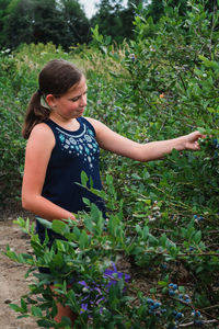 Girl standing by plants