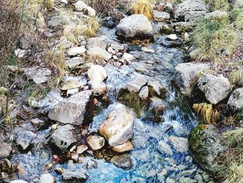 High angle view of pebbles in water