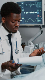 Doctor looking at document in hospital