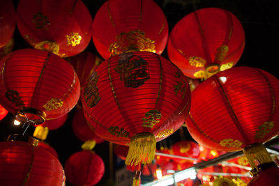 Low angle view of illuminated lanterns hanging at night