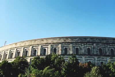 Low angle view of historical building against blue sky