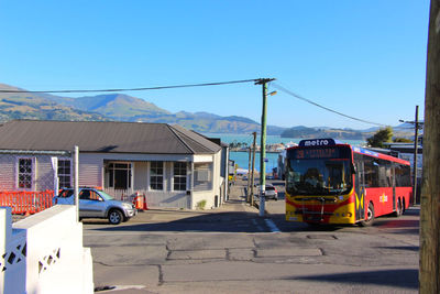 View of street and buildings against blue sky