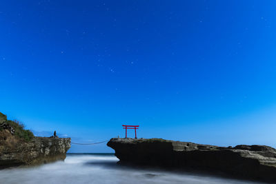 Starry sky over torii gate in the sea at shirahama shrine, izu peninsula, japan