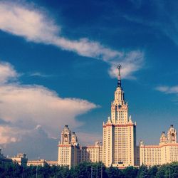 Low angle view of buildings against cloudy sky