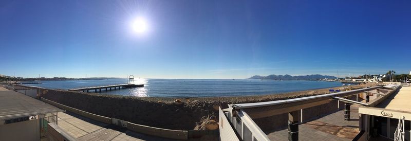 Panoramic view of sea against clear blue sky