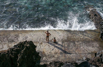 Water splashing on rocks by sea