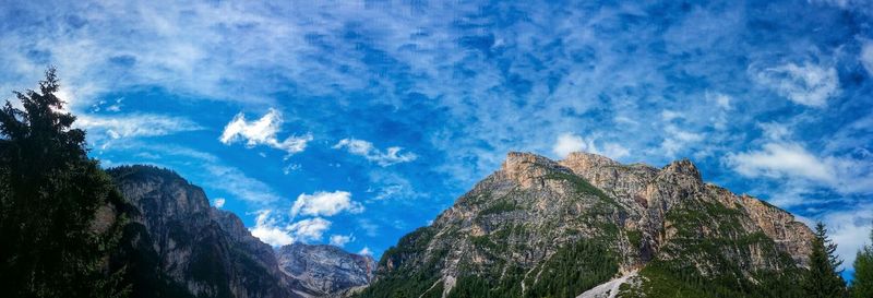 Low angle view of mountain against cloudy sky