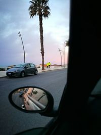 Close-up of man driving car on road