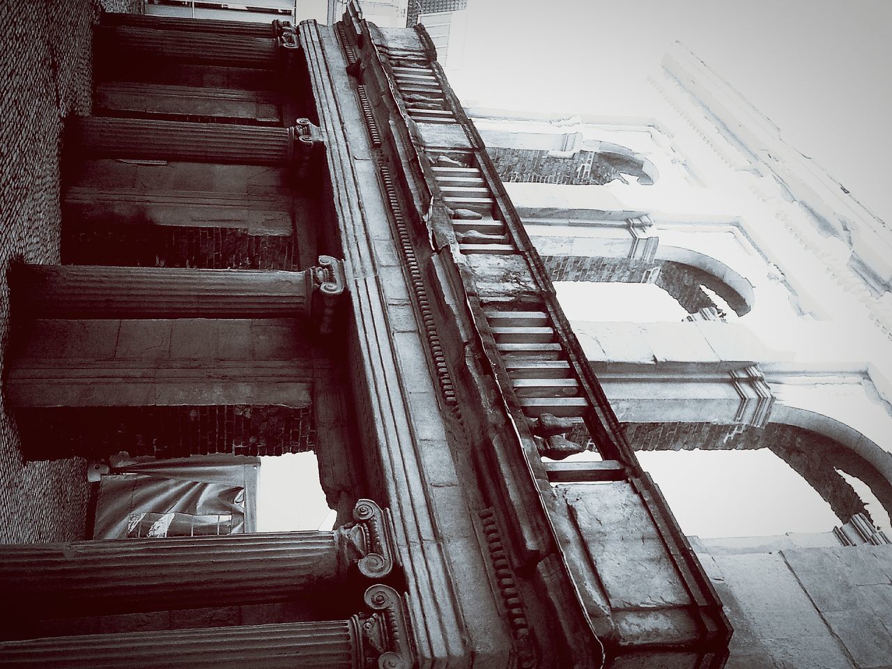 architecture, built structure, building exterior, low angle view, steps, building, staircase, sky, railing, old, house, day, steps and staircases, residential structure, residential building, outdoors, weathered, window, no people, abandoned