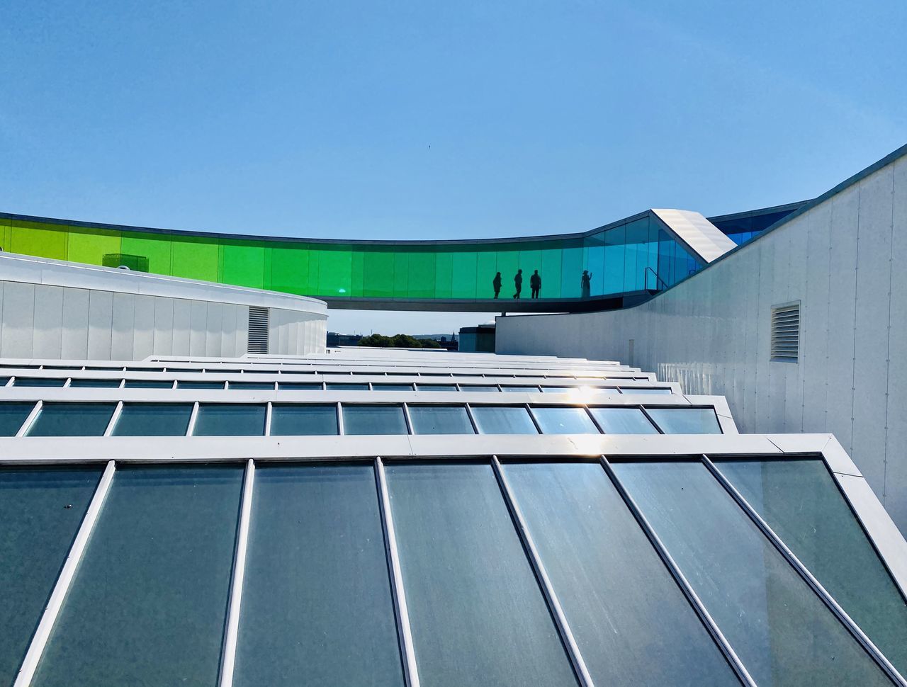 architecture, sky, built structure, solar energy, solar panel, sport venue, facade, renewable energy, alternative energy, stadium, roof, blue, environmental conservation, building exterior, leisure centre, daylighting, power generation, day, nature, clear sky, no people, solar power, outdoors, environment, building, technology