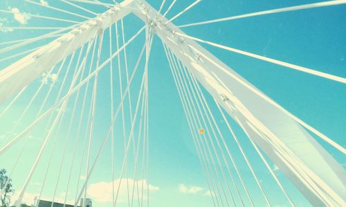 Low angle view of cables against blue sky