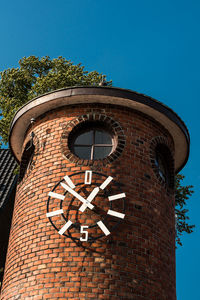 Low angle view of clock tower against sky