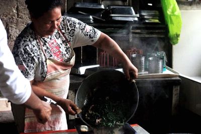 Midsection of man using mobile phone in kitchen