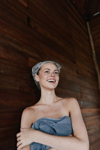 Portrait of young woman sitting on hardwood floor