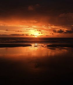 Scenic view of sea against orange sky
