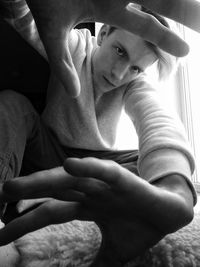 Low angle view of woman holding hands at home