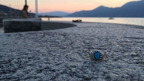 Close-up of water on beach against sky during sunset