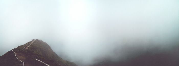 Scenic view of mountains against sky during foggy weather