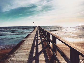 Pier over sea against sky