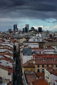 High angle view of buildings in town against sky