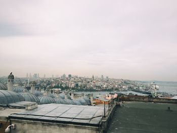 Buildings against cloudy sky