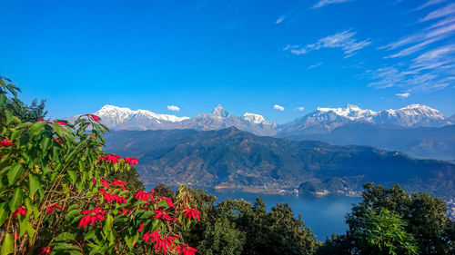 Scenic view of mountains against blue sky