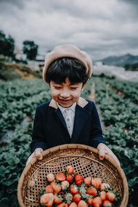 Full length of boy holding ice cream in basket