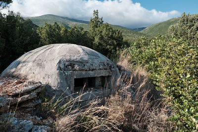 View of cross on land against sky