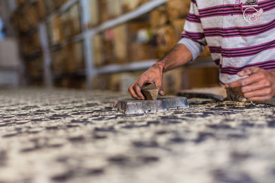 Close-up of man working on fabric block printing