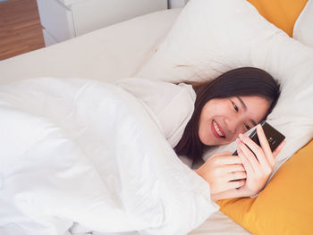 Woman lying down on bed