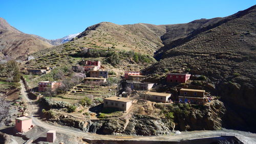 Panoramic view of buildings and mountains against clear sky