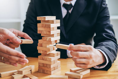 Midsection of man playing with toy on table
