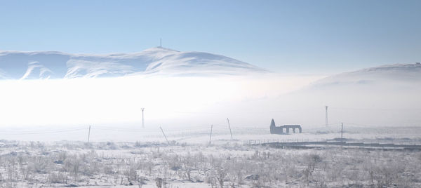 Scenic view of snow covered mountains against sky