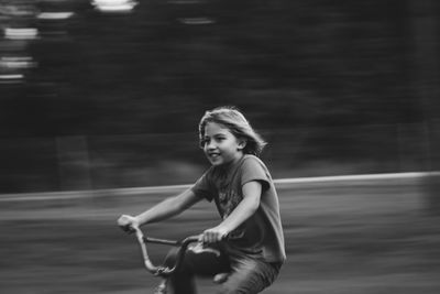 Blurred motion of girl cycling outdoors