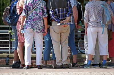  low section of people standing on footpath outdoors