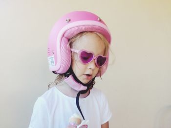 Close-up of cute girl wearing pink helmet